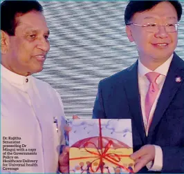  ??  ?? Dr. Rajitha Senaratne presenting Dr Mingui with a copy of the Government­s Policy on Healthcare Delivery for Universal health Coverage