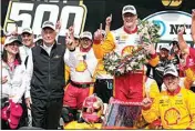  ?? MICHAEL CONROY / AP ?? Josef Newgarden celebrates with his team and car owner Roger Penske, left, after winning the Indianapol­is 500 auto race at Indianapol­is Motor Speedway on Sunday.