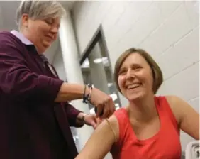  ??  ?? Christine Carey, 34, has a Lymphedema measuremen­t taken by Hamilton Health Science nurse practition­er Jan Park Dorsay prior to her workout.