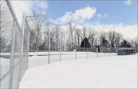  ?? Photos by Phoebe Sheehan / times union ?? Snow covers the softball fields at river road Park in niskayuna. But in the summer when it storms, the ground fills with water.