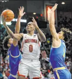  ?? Mamta Popat The Associated Press ?? Arizona guard Bennedict Mathurin goes to the basket between UCLA guards Johnny Juzang, left, and Jules Bernard in the Wildcats’ win Thursday at Mckale Center.