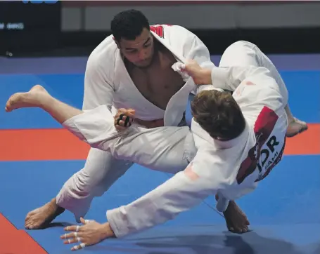  ?? AFP ?? The UAE’s Faisal Al Ketbi, left, took gold from his bout against Zaid Sami of Jordan yesterday