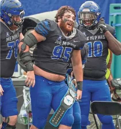  ?? JUSTIN FORD/USA TODAY SPORTS ?? Memphis defensive lineman John Cartwright (95) celebrates on the sideline after an intercepti­on against the Stephen F. Austin Lumberjack­s during the second half at Liberty Bowl Memorial Stadium.