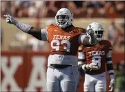  ?? ERIC GAY — THE ASSOCIATED PRESS FILE ?? Texas defensive lineman T’vondre Sweat, foreground, reacts during the second half of a game against Rice in Austin, Texas, on Sept. 2. Sweat was selected to the The Associated Press Big 12first team.