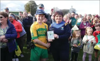  ??  ?? Annacurra goalkeeper Adam Lifely is presented with his Wicklow People Man of the Match award by Katrina Byrne.