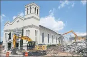  ?? BOB ANDRES / BANDRES@AJC.COM ?? Workers began the demolition of Friendship Baptist Church in July 2014 to make way for the new Atlanta Falcons stadium taking shape just a few yards away.