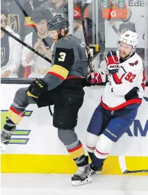  ??  ?? Capitals centre Evgeny Kuznetsov, right, winces after being checked by Golden Knights defenceman Brayden McNabb. Kuznetsov did not return