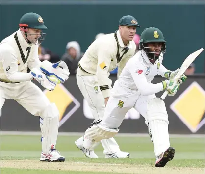  ??  ?? HOBART: South Africa’s Temba Bavuma (R) runs for a quick single as Australia’s wicketkeep­er Peter Nevill (L) looks on during day one of the second Test cricket match between Australia and South Africa in Hobart yesterday. — AFP