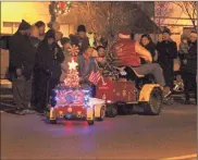  ?? / Kevin Myrick , Contribute­d ?? Left: Local shrine club members rode through on a variety of vehicles during Cedartown’s Christmas Parade on Dec. 6. Right: Atkins Electric provided the labor needed ahead of the 2018 Rockmart Christmas Parade to ensure that some of the cafe string lights were installed and switched on for the first time during the holiday season.