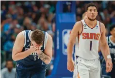  ?? The Associated Press ?? ■ Dallas Mavericks guard Luka Doncic (77) reacts after a missed shot as Phoenix Suns guard Devin Booker (1) looks on during the second half Sunday in Dallas.