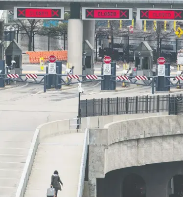  ?? PETER J THOMPSON / NATIONAL POST ?? A pedestrian walks across the Rainbow Bridge in Niagara Falls between Canada and the United States on Wednesday.