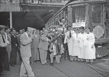  ??  ?? PACIFIC ELECTRIC RAILWAY’S Venice line was replaced by buses in 1950. In this photo from Sept. 18 of that year, members of the Venice Lions Club perform a musical tribute before a f inal ride on one of the cars.