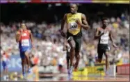  ?? DAVID J. PHILLIP — THE ASSOCIATED PRESS ?? Jamaica’s Usain Bolt anchors the Men’s 4x100m relay team to a win a heat during the World Athletics Championsh­ips in London Saturday.