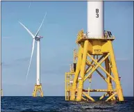  ?? Michael Dwyer / Associated Press ?? Offshore wind turbines near Block Island, R.I. One of two major climate bills signed by Gov. Ned Lamont this week aims to supply all of the state’s power from clean energy sources such as offshore wind by the year 2040.