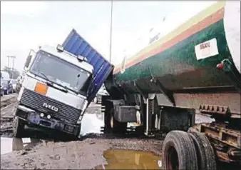  ?? ?? A tanker driver wriggling himself out of one of the nation’s collapsed roads