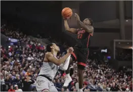  ?? YOUNG KWAK — THE ASSOCIATED PRESS ?? San Diego State guard Darrion Trammell, a Marin City native, shoots while pressured by Gonzaga guard Nolan Hickman during the first half on Friday in Spokane, Wash.