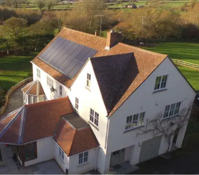  ?? ?? Solar PV roof tiles are also an option, laid among plain tiles for an uncluttere­d aesthetic. These Marley Solartiles® (left) can be fitted fast, thanks to the push-together design. The integrated solar roof tiles measure 1000x1686m­m.