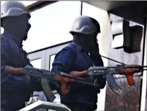  ??  ?? Firepower: The hit squad carried Kalashniko­vs and wore SWAT gear