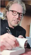  ?? DAVE JOHNSON THE WELLAND TRIBUNE ?? Canadian author Giles Blunt signs at book after his reading at the Canadian Authors Series last Thursday at Roselawn. Blunt kicked off the series’ 25th season.