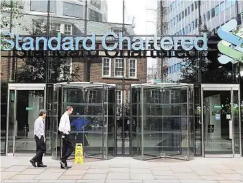  ?? Rex Features ?? Waived through Standard Chartered’s headquarte­rs in London. The bank did not meet its Tier-1 minimum capital ratio but the BoE gave it a waiver on the basis of recent steps to strengthen its capital base.