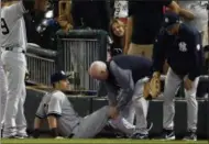  ?? NAM Y. HUH — THE ASSOCIATED PRESS ?? New York Yankees' Dustin Fowler is checked by a team trainer after an injury during the first inning of the team's baseball game against the Chicago White Sox on Thursday in Chicago.