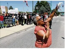  ?? BILL LACKEY / STAFF ?? Denise Williams, president of the Springfiel­d NAACP, leads protesters in a chant during a demonstrat­ion last summer against racial injustice.