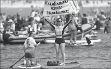  ?? PA ?? Environmen­tal protesters make a point off England’s Gyllyngvas­e Beach, near Falmouth, during the G7 summit in Cornwall on Saturday. A pledge to reach net-zero carbon emissions by 2050 has left activists wanting more. Most of the G7 leaders will meet again in talks this week between transatlan­tic leaders.