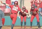  ??  ?? OU's Taylon Snow (5) and Jana Johns (20) greet Lynnsie Elam (22) after Elam's solo home run Sunday in the Sooners' 9-0 win over Texas.