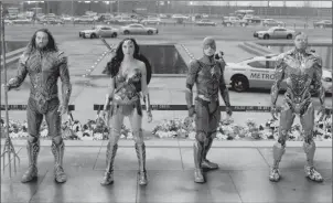  ?? Warner Bros. Pictures/Warner Bros. Pictures — DC Comics ?? The members of the Justice League assemble, from left to right: Jason Momoa as Aquaman, Gal Gadot as Wonder Woman, Ezra Miller as the Flash and Ray Fisher as Cyborg.