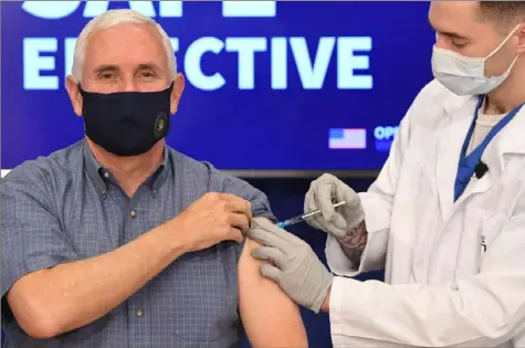  ?? AFP via Getty Images ?? Vice President Mike Pence receives the COVID-19 vaccine on Friday in the Eisenhower Executive Office Building in Washington, D.C.