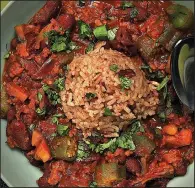  ?? Chicago Tribune/TERRENCE ANTONIO JAMES ?? Red Beans and Chorizo Stew is topped with a scoop of Red Jasmine Rice.