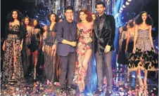  ??  ?? Jacqueline Fernandez and Aditya Roy Kapur showcase a creation by Manish Malhotra during the grand finale of Lakme Fashion Week PIC: AFP