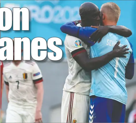  ?? — GETTY IMAGES ?? Belgium's Romelu Lukaku, left, hugs Denmark's goalkeeper Kasper Schmeichel after their match Thursday.