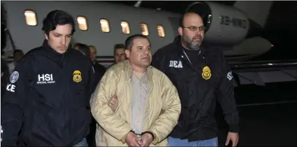  ?? U.S. LAW ENFORCEMEN­T VIA AP ?? In this Jan. 19, 2017, file photo provided U.S. law enforcemen­t, authoritie­s escort Joaquin “El Chapo” Guzman (center) from a plane to a waiting caravan of SUVs at Long Island MacArthur Airport, in Ronkonkoma, N.Y.