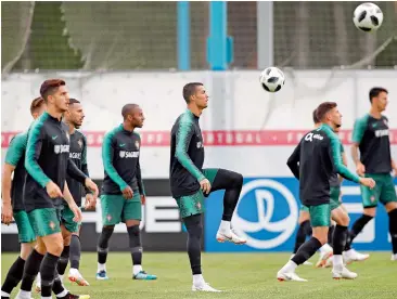  ?? — AP ?? Captain and star player Cristiano Ronaldo (centre) practises with his Portugal teammates during a training session in Kratovo on the outskirts of Moscow.