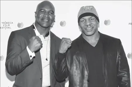  ?? VAN AGOSTINI/INVISION/AP ?? Evander Holyfield (left) and Mike Tyson, pictured at a 2014 film festival, could be set to renew their ring rivalry with an exhibition bout in May, continuing the trend for former pros to fight in live-streamed pay-per-view events.
