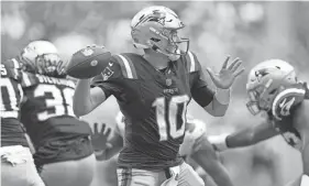  ?? JIM RASSOL/USA TODAY NETWORK ?? Patriots quarterbac­k Mac Jones (10) drops back to pass against the Dolphins during the second on Oct. 29 at Hard Rock Stadium in Miami Gardens.