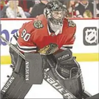  ?? GETTY ?? Scott Foster was at his accounting job Thursday before the Blackhawks needed him to tend goal.