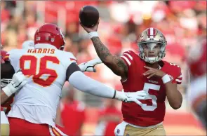  ?? The Associated Press ?? San Francisco 49ers quarterbac­k Trey Lance passes against Kansas City Chiefs defensive end Demone Harris during an NFL preseason game in Santa Clara, Calif., Saturday.