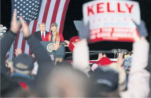  ?? BLOOMBERG ?? Senator Kelly Loeffler, a Republican from Georgia, joins US President Donald Trump at a campaign rally in Dalton on Monday.