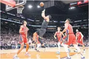  ?? AFP ?? The Suns’ Devin Booker attempts a shot over the Pelicans’ Trey Murphy III during the first half of their NBA game.