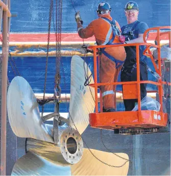  ?? KEITH GOSSE THE TELEGRAM ?? Workers at Newdock in St. John’s hoist a ship’s propeller into place as it was being installed on the towing ship Atlantic Fir Friday afternoon. According to the latest labour force survey released Friday, Newfoundla­nd and Labrador regained 10,000 jobs in May.
