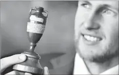  ??  ?? England captain Joe Root gestures as he displays the Ashes urn ahead of the England cricket team’s departure to Australia for the Ashes tour, at Lord’s Cricket Ground in London. — AFP photo