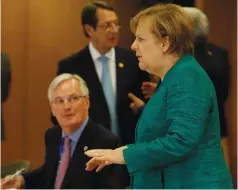  ??  ?? GERMAN CHANCELLOR Angela Merkel speaks Friday at the Brexit summit in Brussels as EU chief Brexit negotiator Michel Barnier looks on.