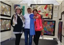  ??  ?? At the 2018 Hot Works Estero Fine Art Show , winning fiber artist K evin Kichar celebrates with Marianne Mege la, artist judge ( left), and P atty Narozny, the event’s executive producer .