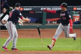  ?? ASSOCIATED PRESS ?? tosses his bat to first base coach Tim Bogar after his home run against the Houston Astros during the fifth inning of Game 6 of the World Series in Houston.