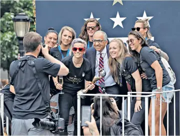  ??  ?? Tough at top: US Soccer Federation President Carlos Cordeiro poses with players but has been in dispute with them over equal pay