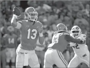  ?? The Associated Press ?? GATOR ROMP: Florida quarterbac­k Feleipe Franks (13) throws a pass Saturday during the first half of a 48-10 win against Colorado State in Gainesvill­e, Fla.