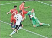  ?? Dmitri Lovestky / The Associated Press ?? Germany goalkeeper Marc-Andre Ter Stegen (right) makes a save next to Chile’s Alexis Alejandro Sanchez (top) and Charles Mariano Aranguiz Sandoval (left) during the Confederat­ions Cup final soccer match between Chile and Germany on Sunday at the St....