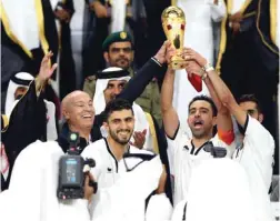  ?? AFP ?? DOHA: Al-Sadd’s Spanish capitan Xavi (2nd-R) lifts the Qatar Emir Cup following the final football match between Al-Sadd and Al-Rayyan at the Khalifa Internatio­nal Stadium.—